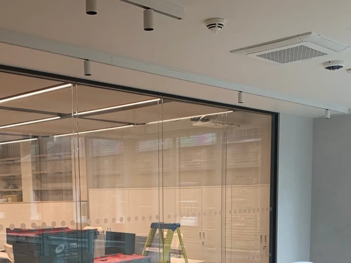 Ceiling detection and lighting going in behind the glazed shopfront of a Dior boutique