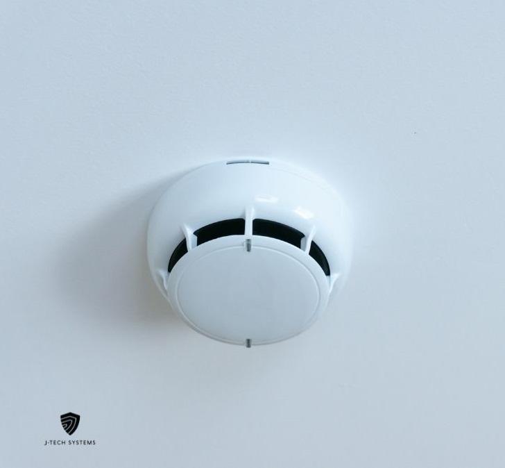White ceiling-mounted smoke detector, branded J-Tech Systems