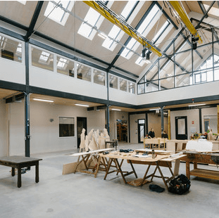 Glyndebourne Production Hub workshop with exposed roof glazing and workbenches